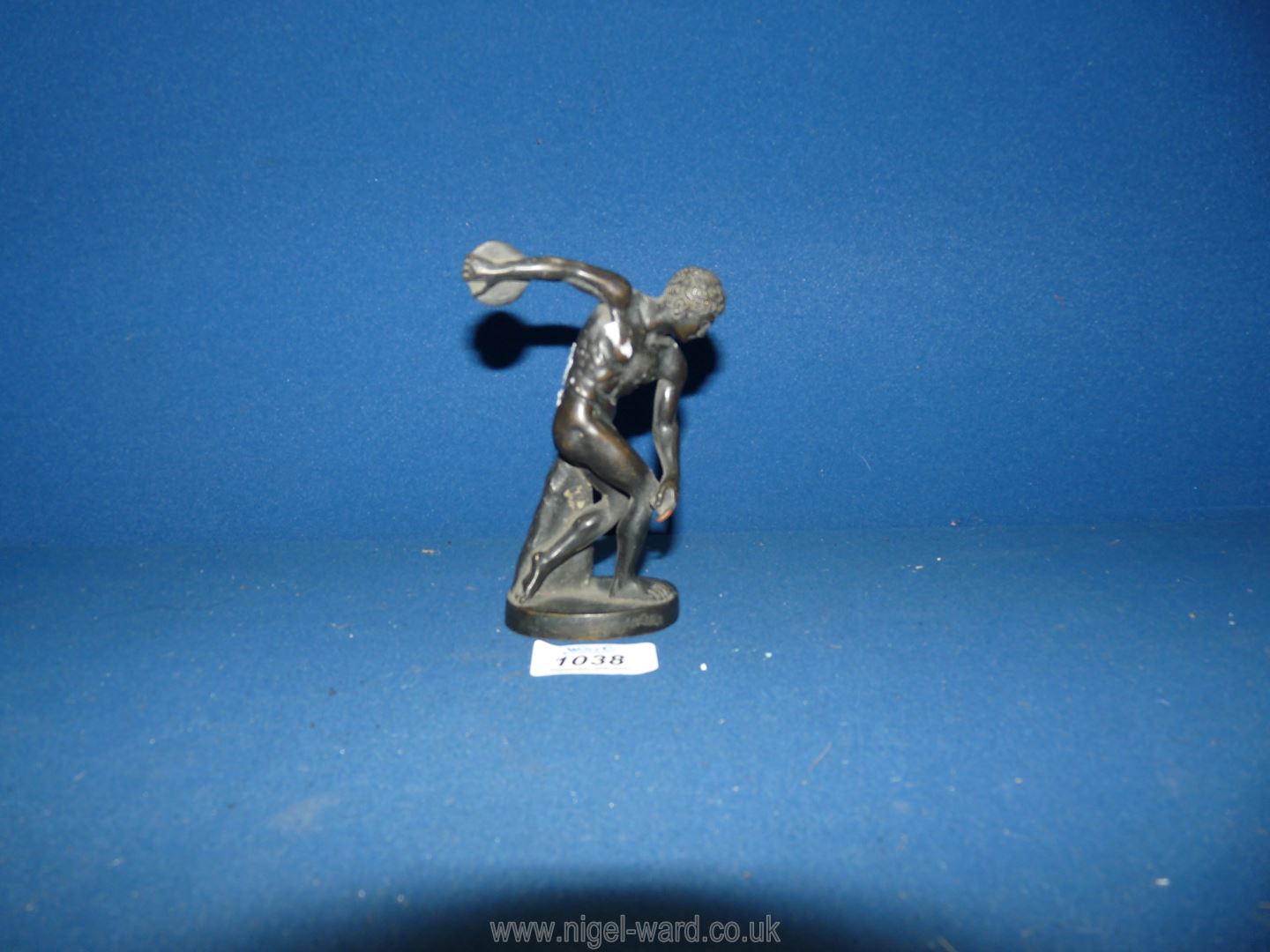 A bronzed finish brass figure of a discus thrower, 5'' tall.
