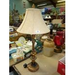 A table lamp with gold effect detail and a cream shade. 33" tall.