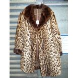 An Ocelot fur Coat with brown turned down collar and sleeve having embroidered detail to the lining,