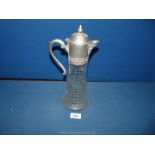 A white metal topped claret jug.