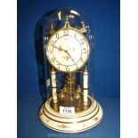 A glass domed Kundo anniversary Clock with painted roses, 11 1/2'' tall.