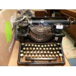 A black vintage typewriter with soft case.