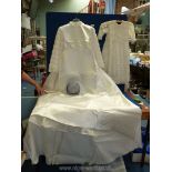A satin wedding dress with pearl and lace detail to collar and sleeves,