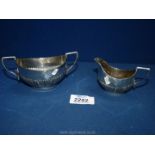 A Birmingham silver cream jug and two handled sugar bowl, possibly 1910, 'W.A.' makers mark.