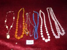 A small quantity of glass bead necklaces and a coral style necklace