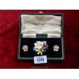 A Royal Crown Derby boxed floral brooch and earrings, damage to petals.