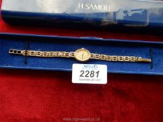 A H. Samuel quartz ladies watch with gold coloured chain.