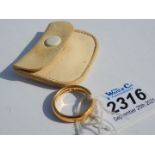A 22 carat gold wedding band having a cream leather pouch, inside diameter 18 mm, 8 gms approx.