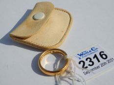 A 22 carat gold wedding band having a cream leather pouch, inside diameter 18 mm, 8 gms approx.