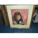 A framed and mounted oil painting of a young girl and her cat,