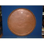 A large copper tray, 3' diameter.
