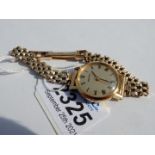 A "Seiko" lady's wristlet watch having a 9 carat gold gate-style bracelet,