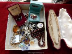 A quantity of costume jewellery to include; brooches, clip on earrings, embroidered scarf ring, etc.