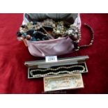 A pink bag of mixed necklaces, two boxed pearl necklaces etc.