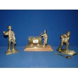 Three brass mining figures.