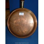 A brass warming pan.