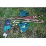 Garden tools including saw, broom and leaf grabbers.