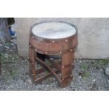 A garden table made from recycled whisky barrel.