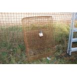 A large wire mesh office letter box.