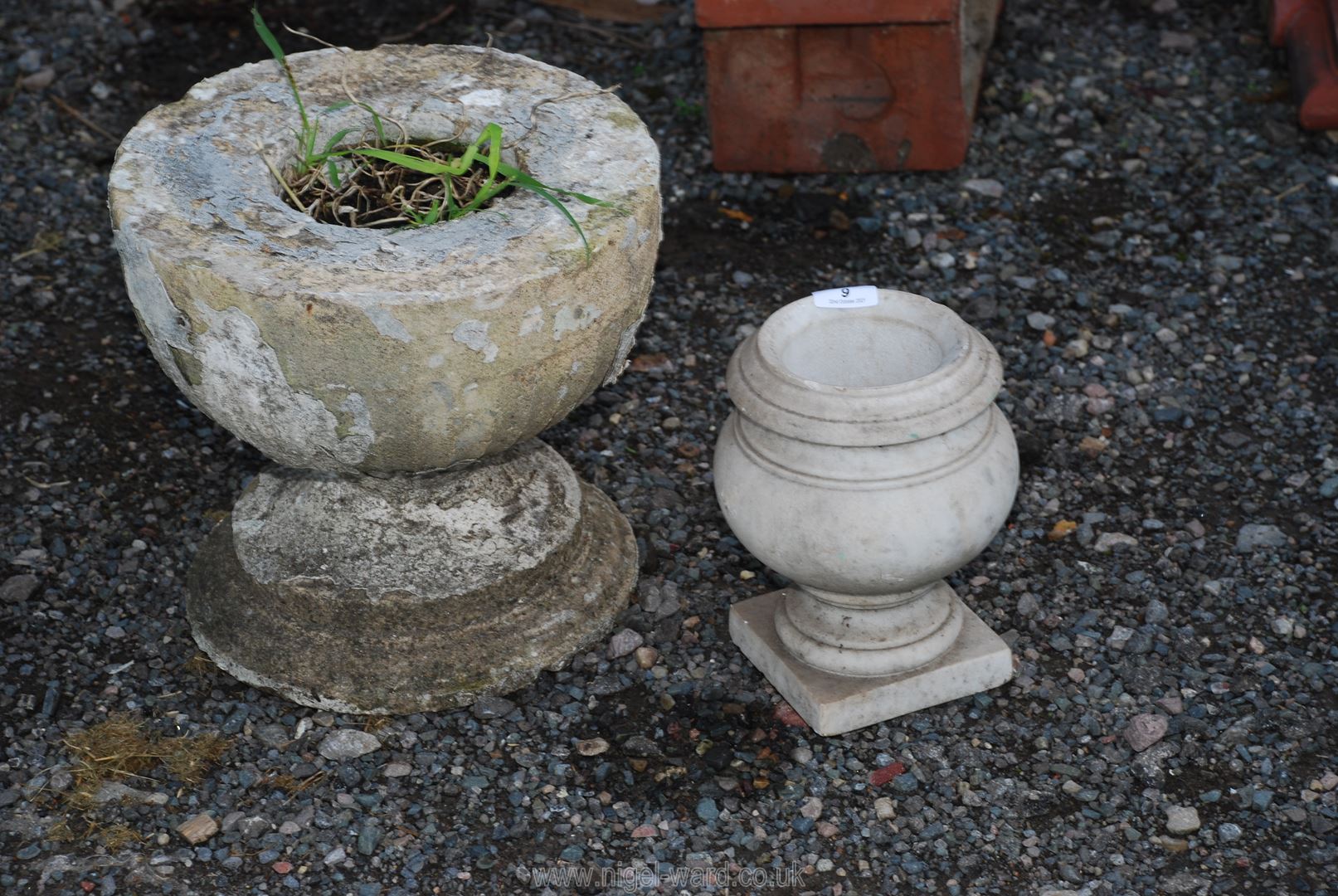 A small marble urn and concrete planter/base.