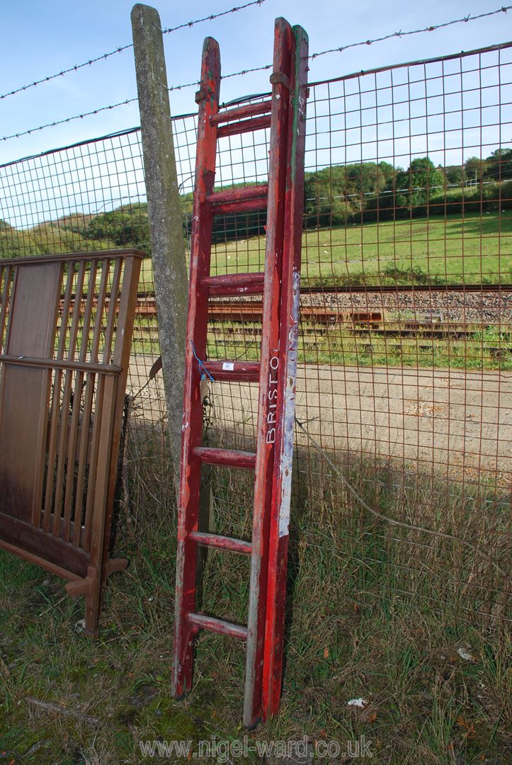 A wooden seven rung double extension ladder.