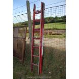 A wooden seven rung double extension ladder.