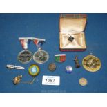 A small box of badges and Coronation medals, etc.