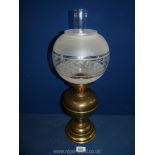 A Victorian double burner oil Lamp with frosted globe and on brass base, 20 1/2'' tall.