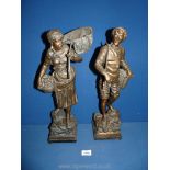 A pair of Spelter figures; one of a lady with her fishing net and basket of fish,