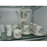 A Portmeirion pottery coffee set in floral design; six setting (one cup having had handle off),