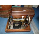 A cased Singer hand sewing machine, no. 14707239.