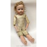 A German doll with porcelain head, hands and feet with closing eyes, a leather body,