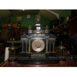 A heavy slate garniture of mantle clock with a pair of temple style side pieces,
