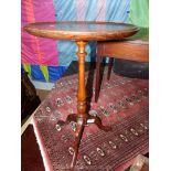 A Mahogany wine Table, the circular top supported on a turned pillar with three splay feet,
