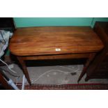 A circa 1900 Mahogany flap-over Tea Table standing on slender turned legs terminating on miniature