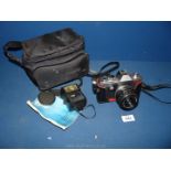 A Practika Super TLS Camera and flash gun, with case, instruction manual, plus Pentacon Auto f/1.