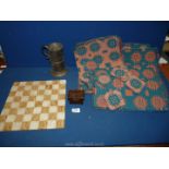 An onyx chessboard with brass tankard and small wooden box and nine Welsh wool place settings.