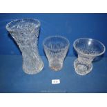 Three various sized cut glass vases; one with the initials 'A & H', one A/F.