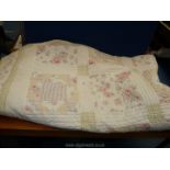 An American style Quilt in pink floral and white,