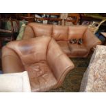 A two piece brown hide upholstered Lounge Suite comprising a three seater settee and a single