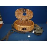 A vintage wicker Creel and a large deep sea fishing Reel with Bakelite handles, 6'' diameter.