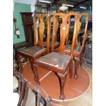 A set of four Queen Anne style Mahogany dining Chairs having cabriole legs terminating in ball and