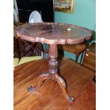 A circa 1900 pie-crust edged Mahogany circular occasional Table standing on a turned and carved