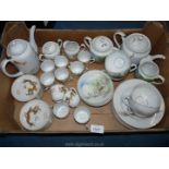 A Japanese coffee set with dragon design and teaset with scenes of pagoda, huts and boats,