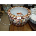 A large oriental jardiniere with painted Koi Carp to the interior and floral,