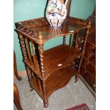 A 19th Century rosewood serpentine fronted three stage Etagere/whatnot having a mixture of turned