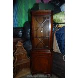 A contemporary Mahogany full height Corner Cabinet over Cupboard having dentil frieze and 13 pane