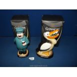 Two boxed Guinness china money boxes in the form of 'Pelican' and 'Zoo keeper'.