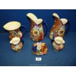 A quantity of Hollingshead and Kirkham of Tunstall jugs and pin dishes in 'Viola' pattern.