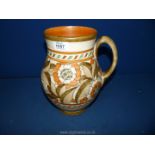 A large Charlotte Rhead jug in Art Deco form with floral decoration in cream and orange,